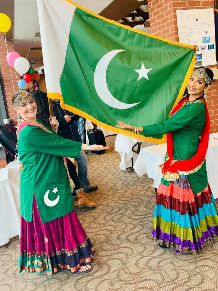 Dancers holding Pakistan flags
